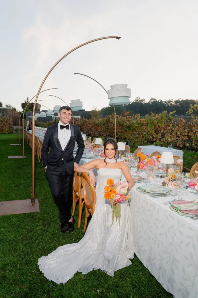 Bespoke floral arch and outdoor reception table set against the vineyard at Monverde Hotel, Portugal